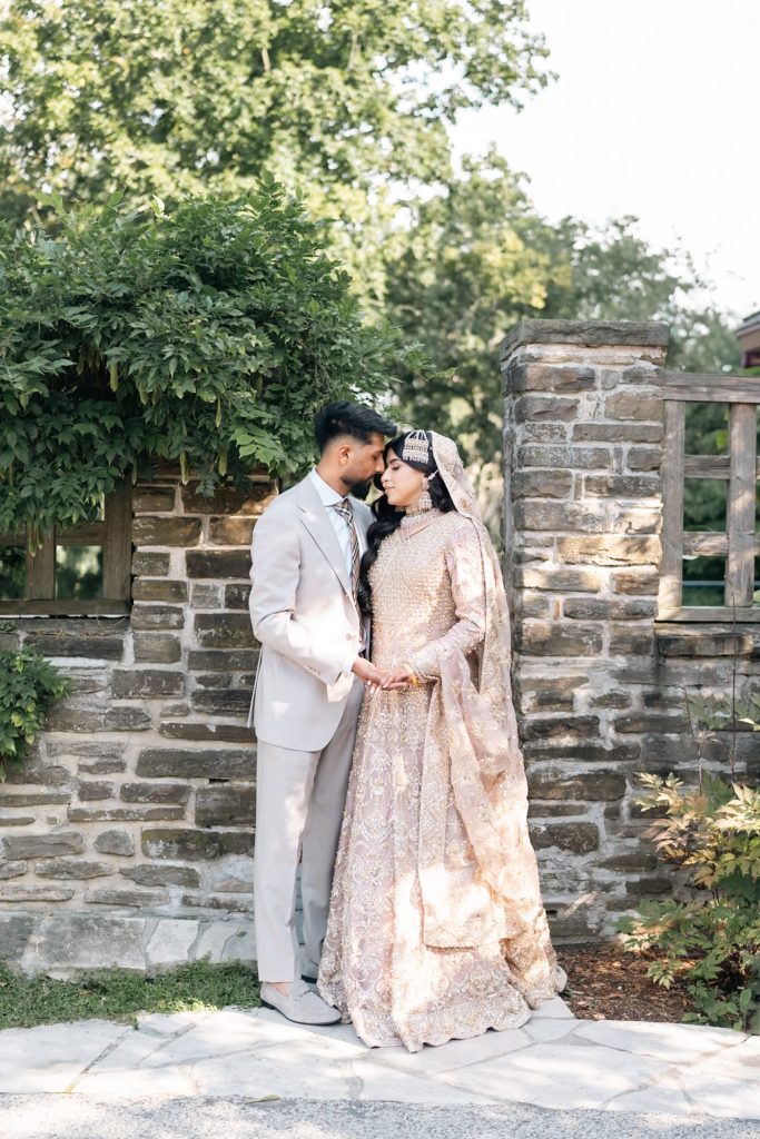 Bride and groom posing near greenery for wedding photography Mississauga