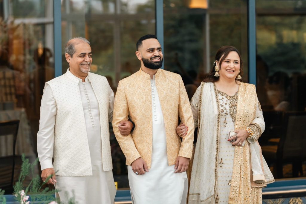 Hamza and his parents in gold attire