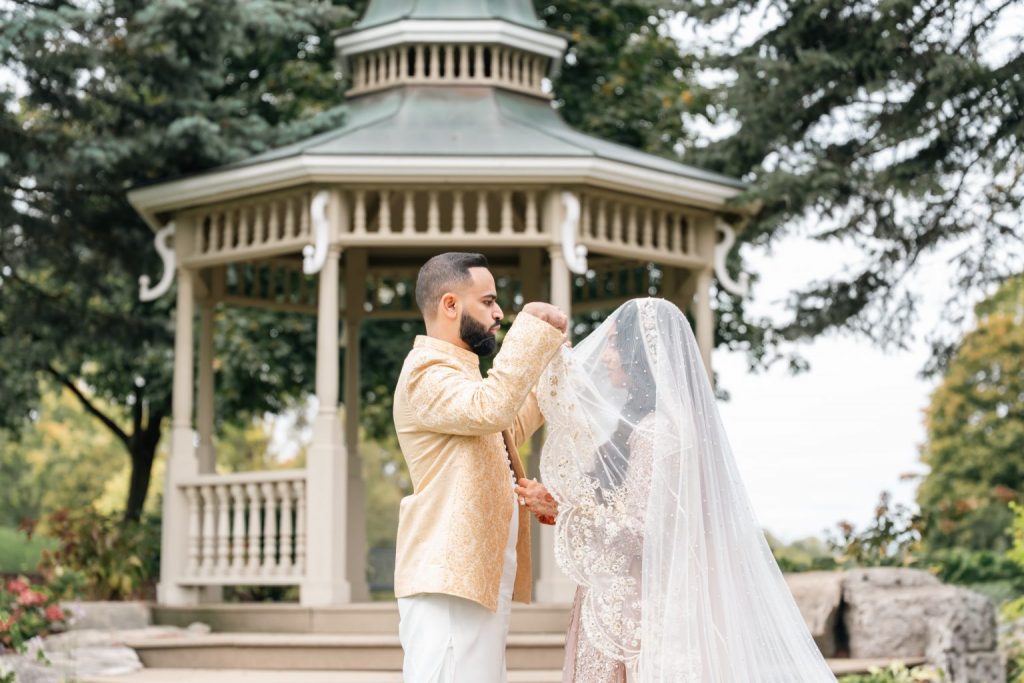 Muslim groom lifting bride veil gazebo Nikkah Brampton